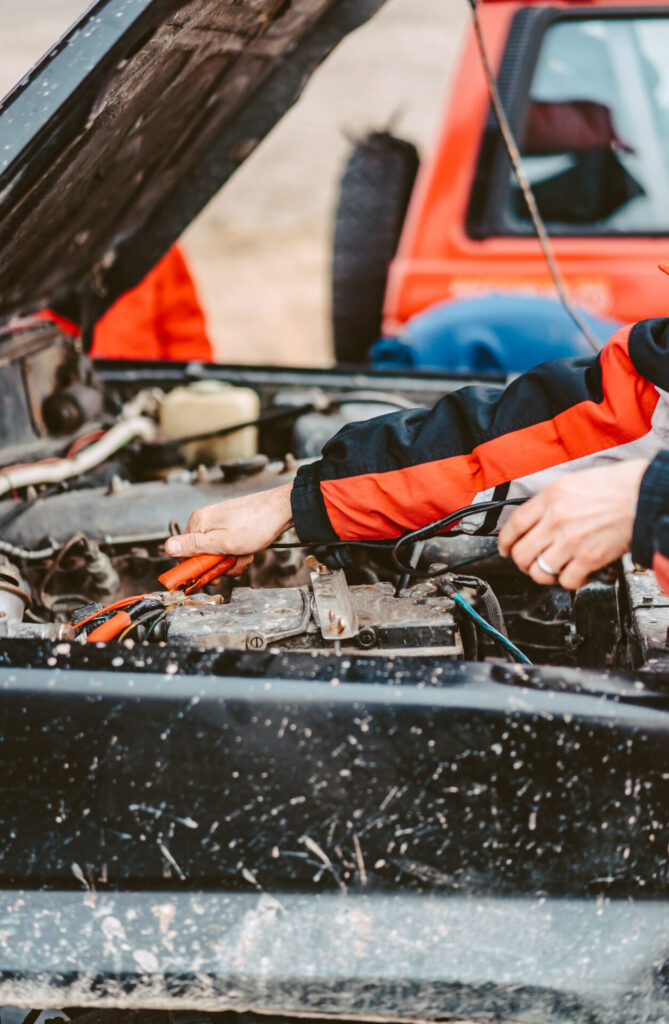 Jump starting the dead battery using jumper electrical wires.